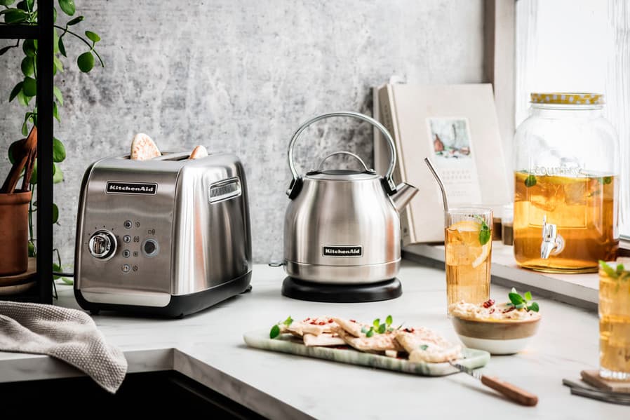 Stainless steel electric kettle beside a matching two-slice toaster